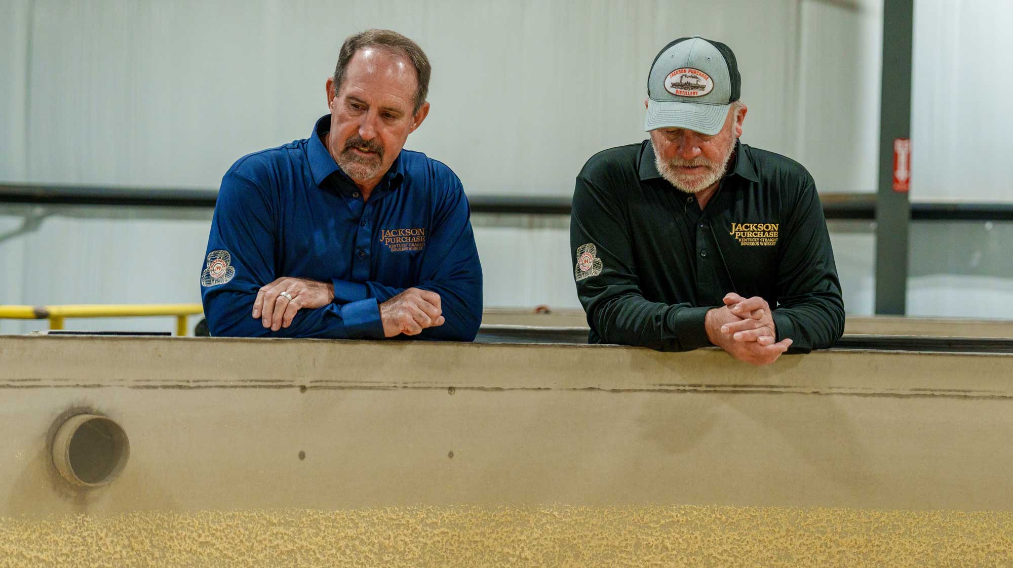 Craig Beam and Terry Ballard around bourbon mash
